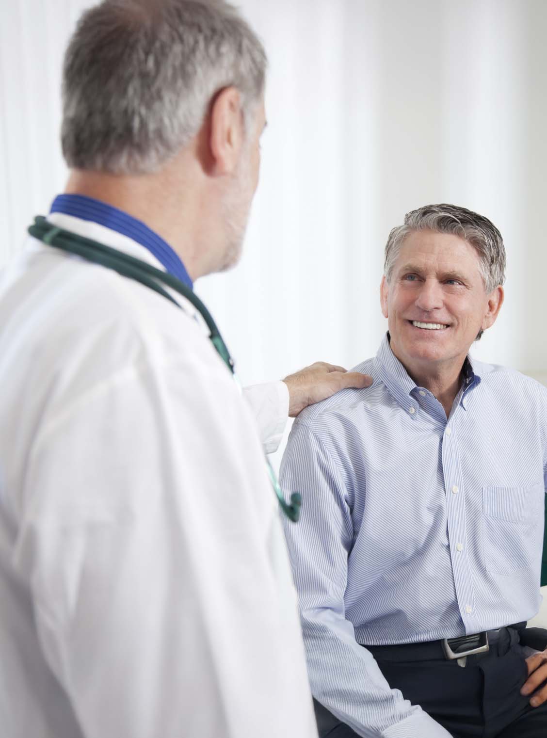 hill-physicians-serving-members-colorectal-screenings Male doctor and smiling male patient