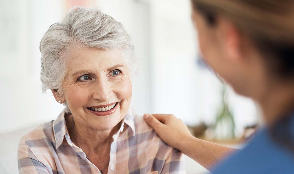hill-physicians-serving-physicians-savings Elderly female patient with female doctor’s hand on her shoulder
